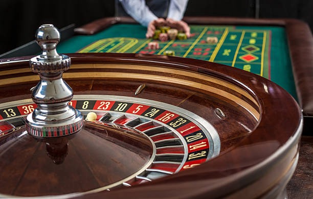 Live dealer handling cards during a baccarat round